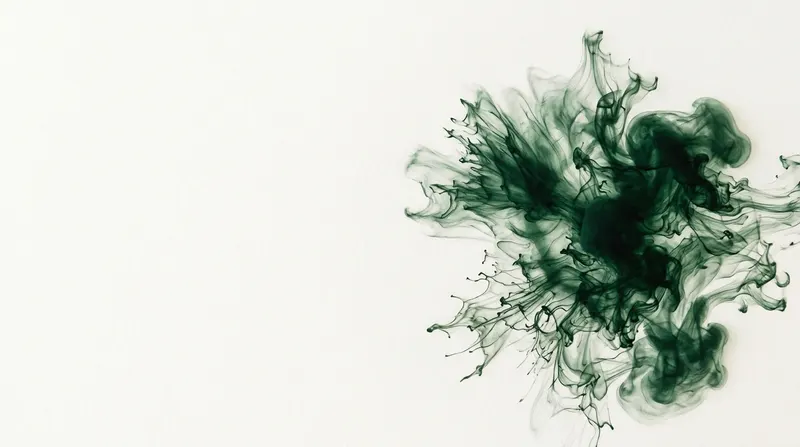 A bloom of green ink spreading through water